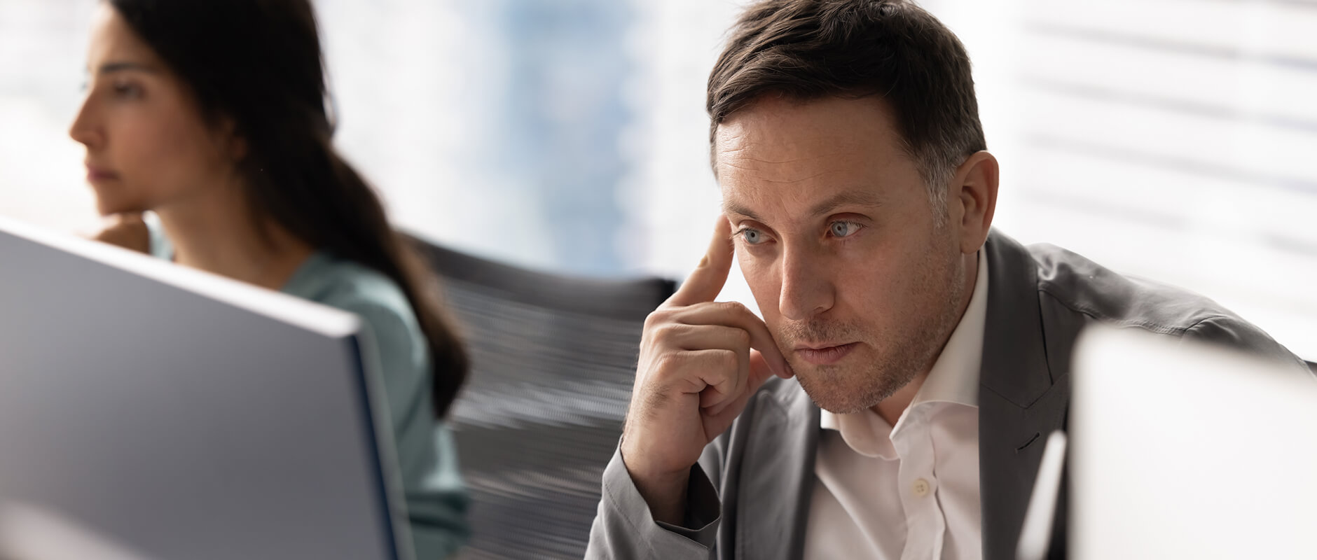 man thinking, looking at computer